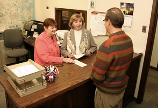 The County Clerk assists a resident