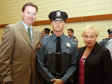 Asbury Park police officer Gregory W. Parisi with Freeholder Director Lillian G. Burry and Deputy Director Robert D. Clifton. Asbury Park police officer Gregory W. Parisi with Freeholder Director Lillian G. Burry and Deputy Director Robert D. Clifton.