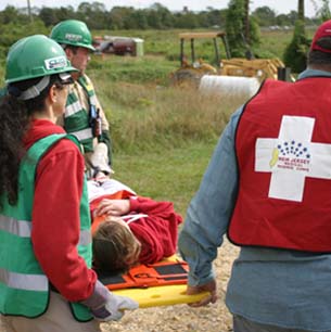 CERT and Medical Reserve Corp. volunteers carry a victim during a simulated exercise/drill