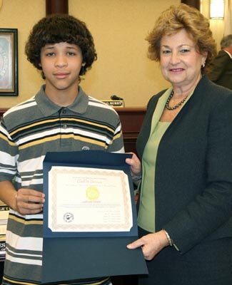 Freeholder Director Barbara McMorrow presents a Call to Service proclamation to Jordan Davis