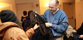 A participant in Monmouth County's Project Homeless Connect gets some assistance in finding a new coat from United Way of Monmouth County President Timothy C. Hearne, Jr. Other volunteers assisted with health screenings and serving food to the attendees. A participant in Monmouth County's Project Homeless Connect gets some assistance in finding a new coat from United Way of Monmouth County President Timothy C. Hearne, Jr. Other volunteers assisted with health screenings and serving food to the attendees.