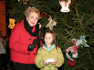 Freeholder Director Lillian Burry helps light the tree with Molly Holtz of Freehold Borough