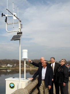 Freeholder Curley examines a flood gauge unit on the Shrewsbury River Freeholder Curley examines a flood gauge unit on the Shrewsbury River