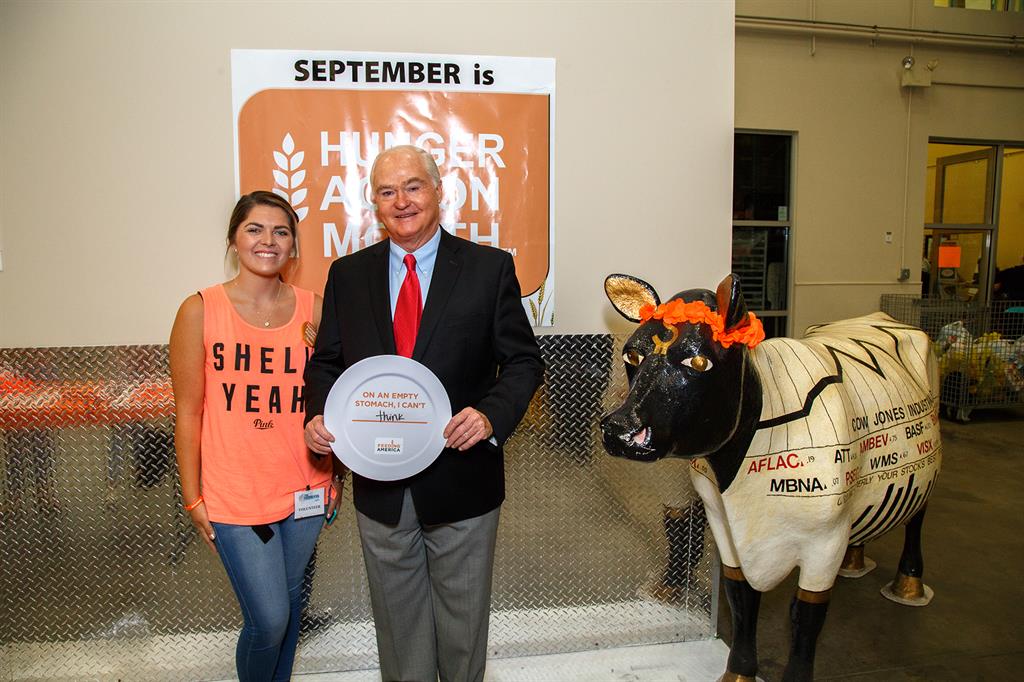 Volunteer Rachel Marconi and Freeholder John P. Curley participate in Hunger Action Family Day at the Monmouth County FoodBank of Monmouth and Ocean Counties to kick off Hunger Action Month on Sept. 1 in Neptune, NJ.